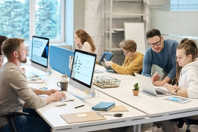 Website Development for Tradesmen A group of Velderra software engineers collaborating in the office, developing websites and optimising SEO strategies for tradesmen.